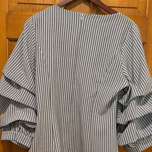 Shirt for work or night out.  Full zipper on back. Ruffle sleeves. Hand Wash.